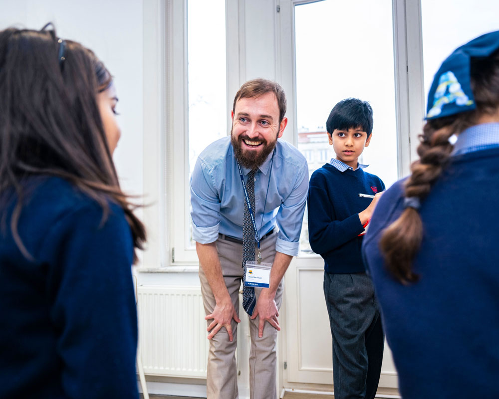 A member of staff with students at BJAB.