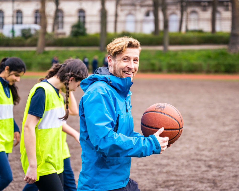 A member of staff teaching sport at BJAB.